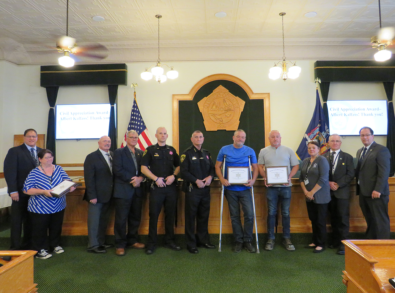 sheriff presents certificates to citizens for heroic actions